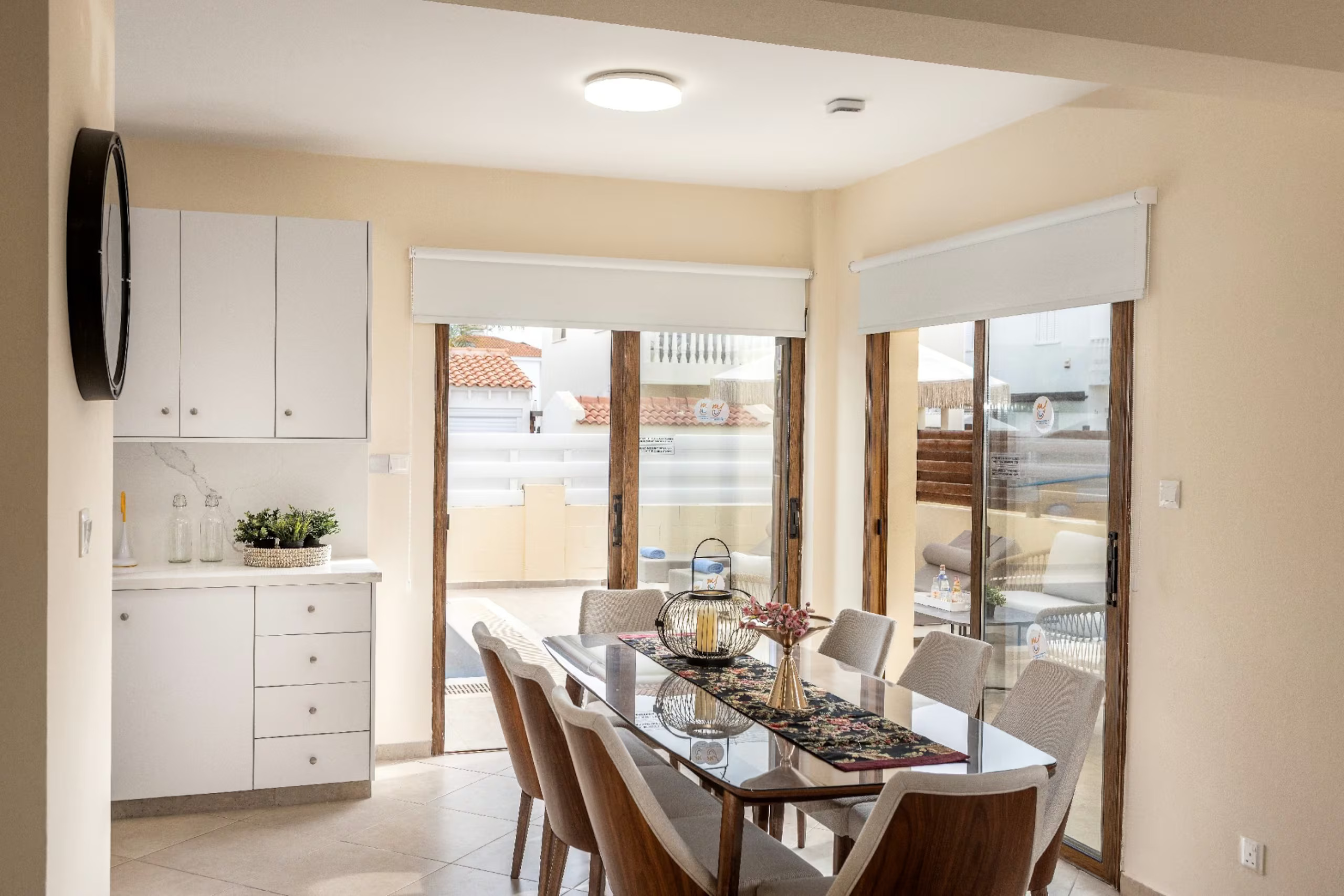 Villa Poseidon dining table beside sliding doors to the terrace
