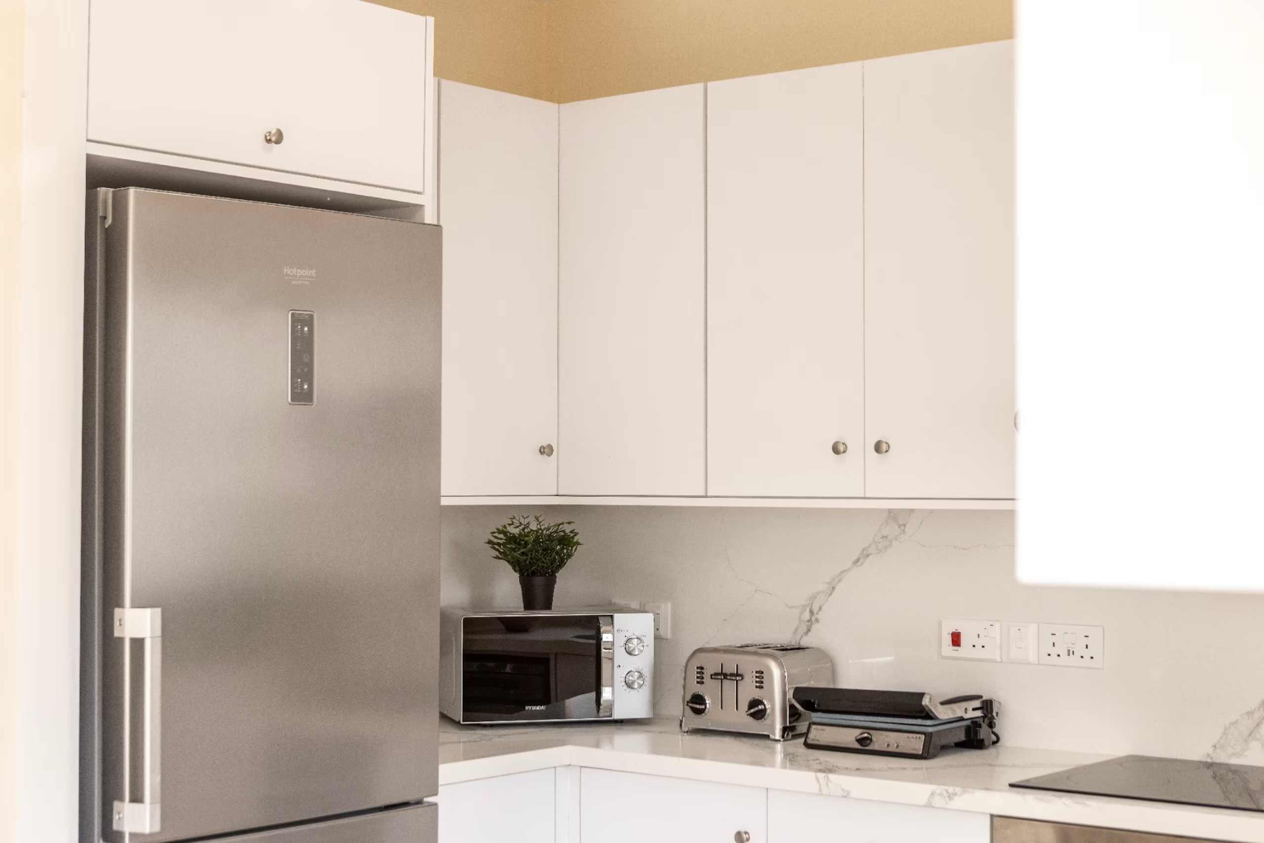Fridge freezer, microwave, toaster and sandwich maker in Villa Poseidon's kitchen