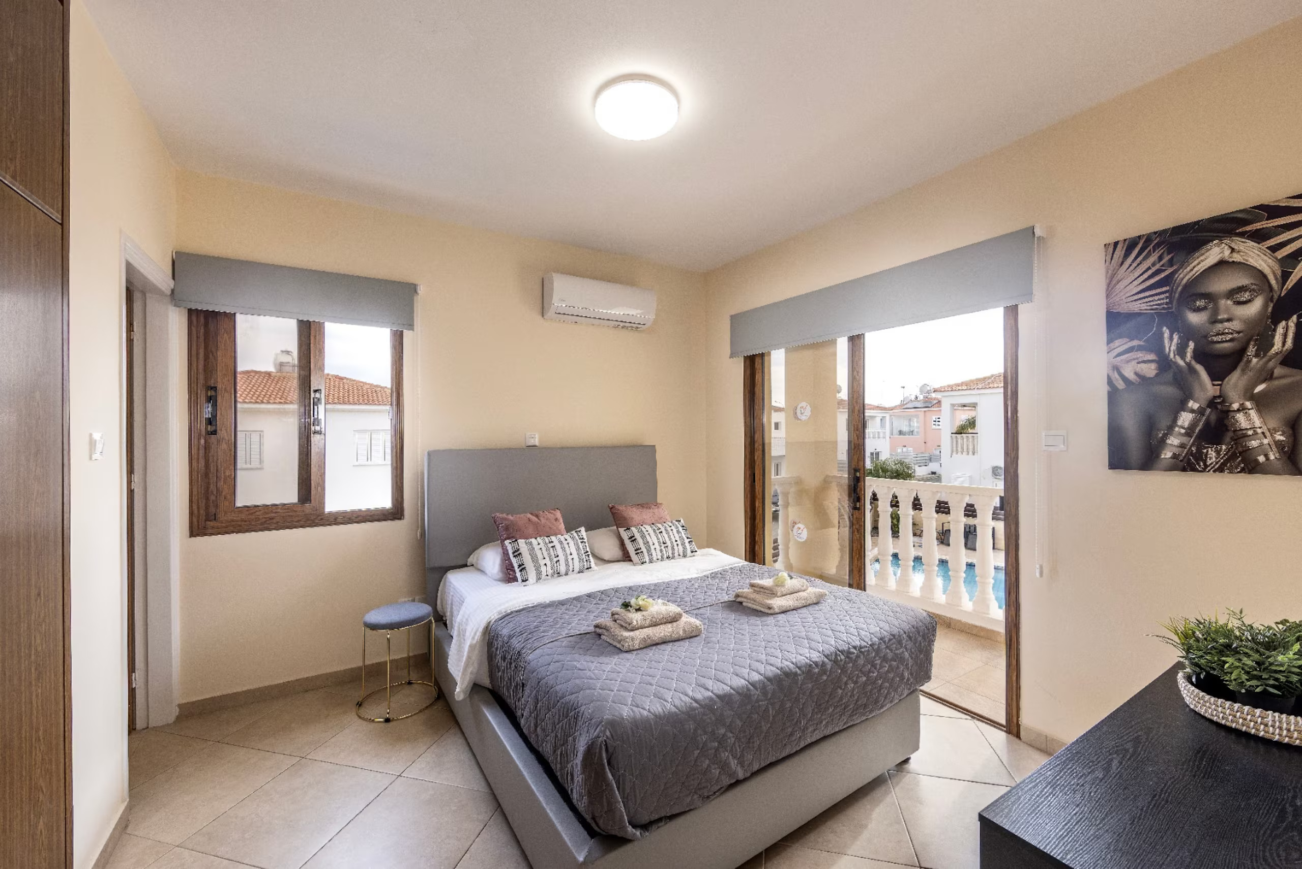 Villa Poseidon master bedroom with double bed and balcony doors