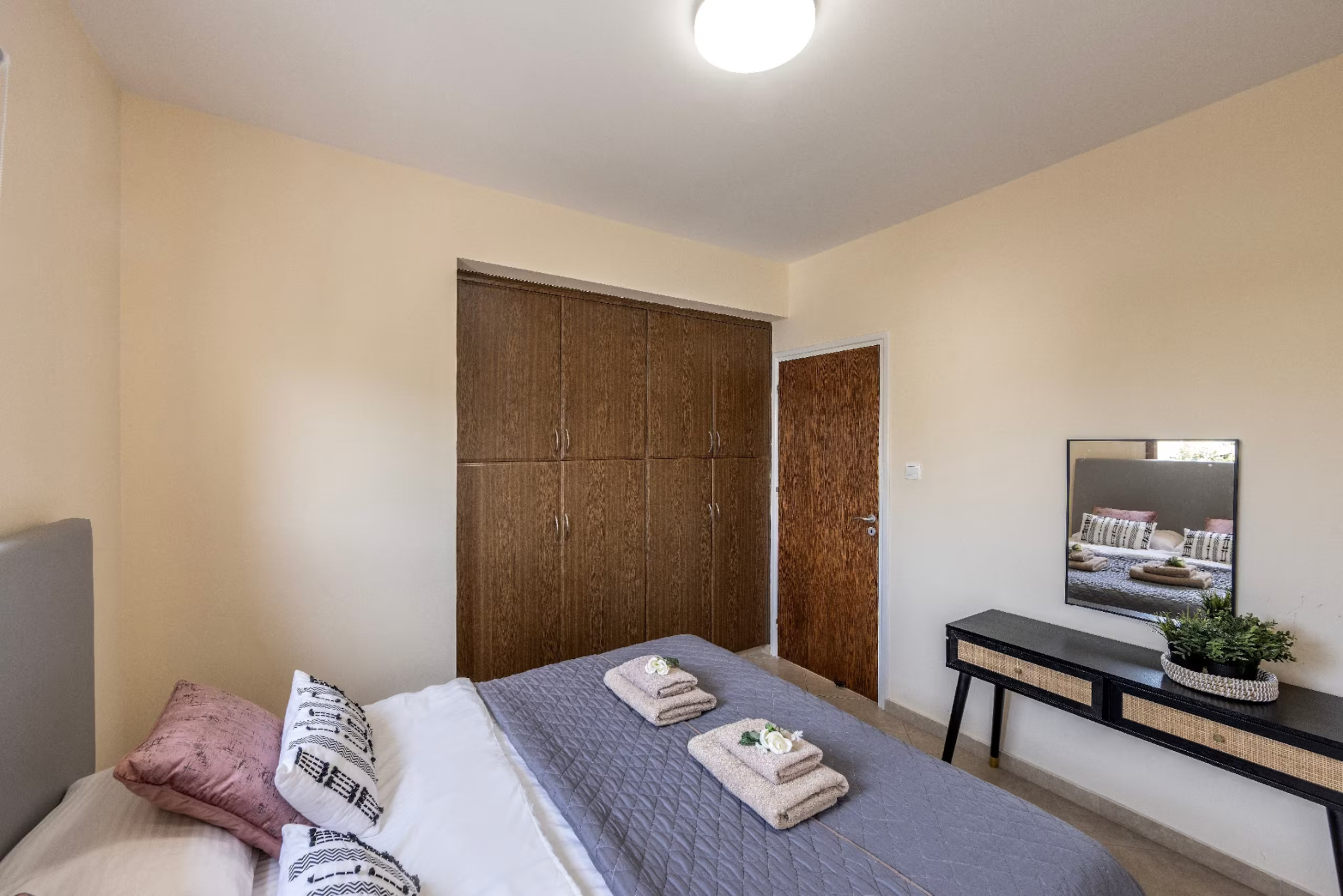 Upstairs double bedroom with wooden wardrobe and dressing table